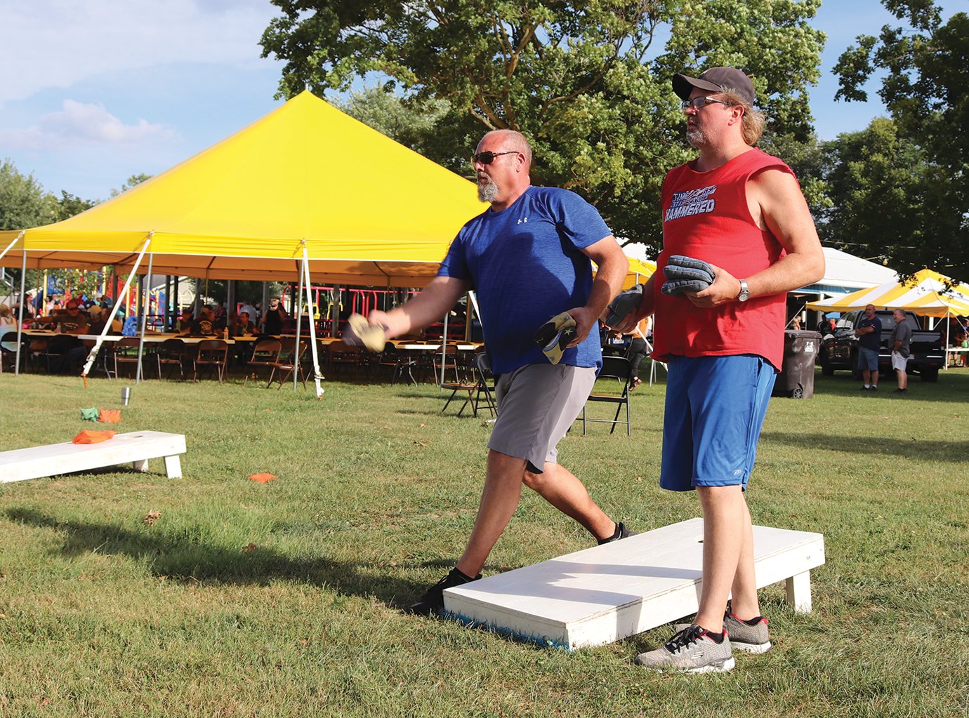 Rich Mesaros, left, and Larry McKinsey take turns throwing Saturday during a cornhole tournament at the Darren Forman Fundraiser in Waynetown. The event at Tremaine Park was created to benefit Montgomery County Coroner and Crawfordsville firefighter Darren Forman, who was seriously injured in July.